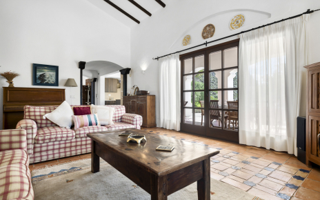 Living room with doors opening to furnished terrace